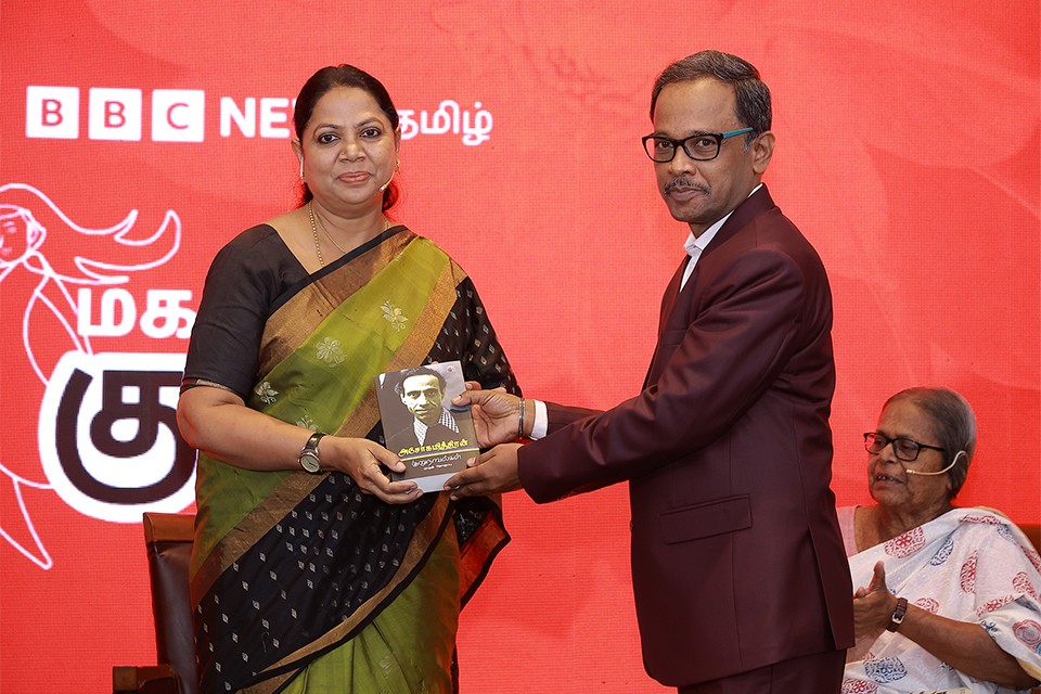 Tamil Editor felicitating a guest on stage